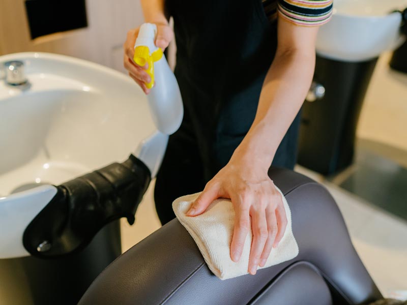 hair stylist cleaning chair